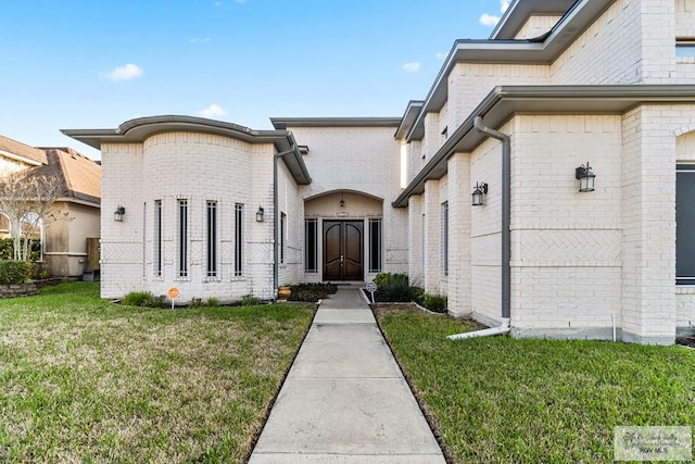 doorway to property with a lawn