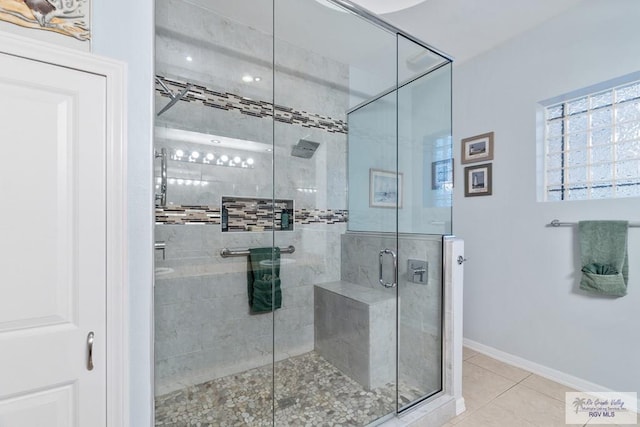 bathroom featuring a shower with door and tile patterned floors