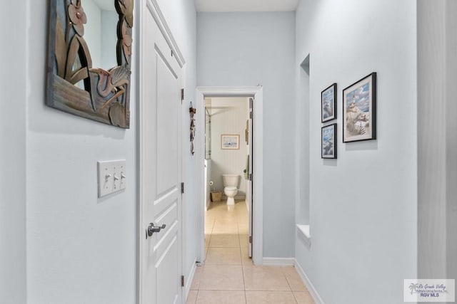 hall featuring light tile patterned floors