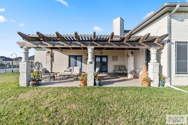 back of property featuring a pergola, a patio area, french doors, and a lawn