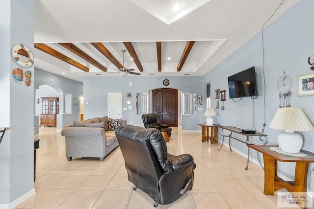 tiled living room featuring beam ceiling and ceiling fan