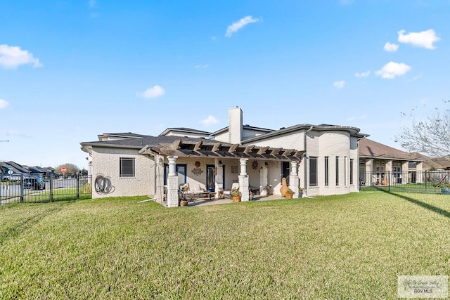 rear view of property with a yard, a patio area, and a pergola