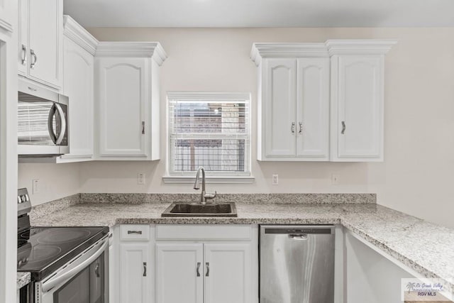 kitchen featuring white cabinets, sink, and appliances with stainless steel finishes