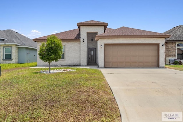 view of front of property with a front yard and a garage