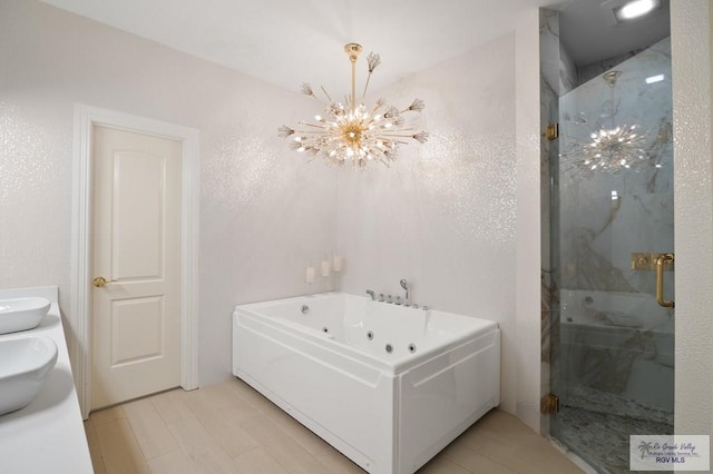 bathroom with vanity, plus walk in shower, and a chandelier