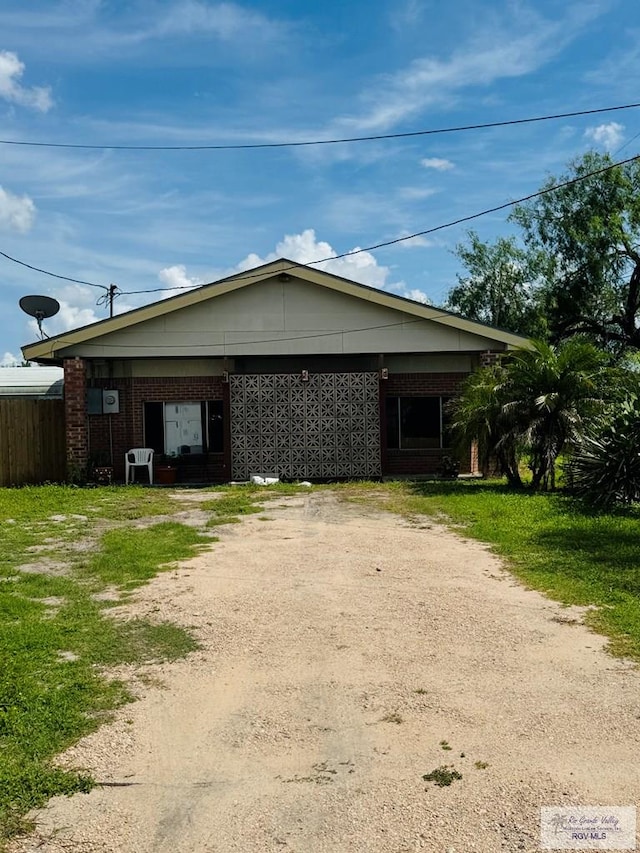 2605 Wilson Rd, Harlingen, TX 78552 - view of side of home with driveway and brick siding