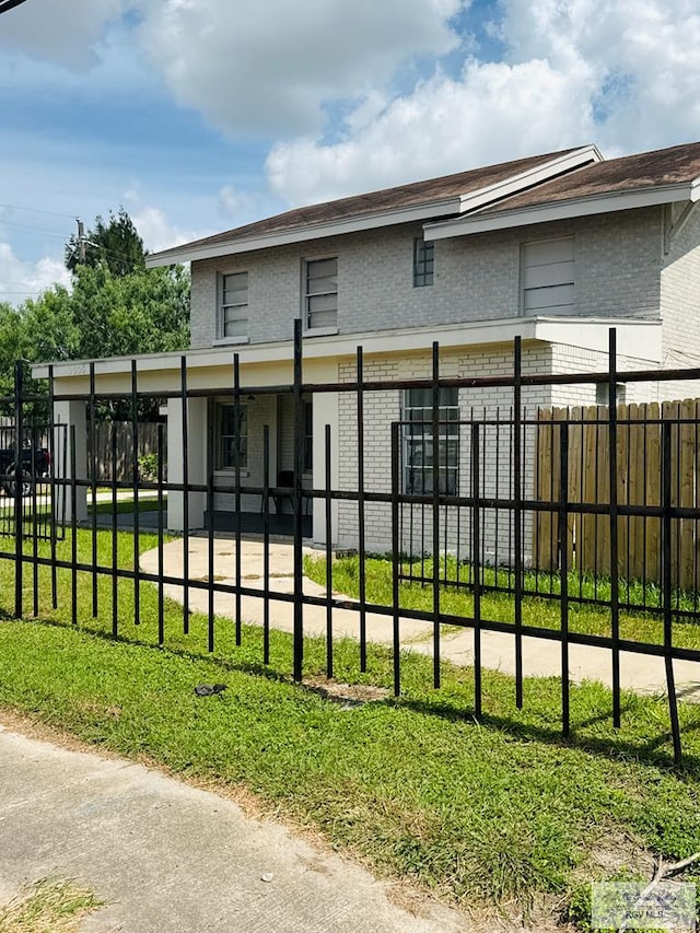 2605 Wilson Rd, Harlingen, TX 78552 - back of house featuring brick siding and a fenced front yard