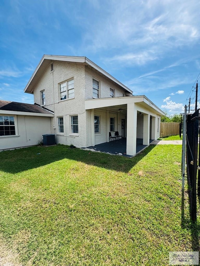 2605 Wilson Rd, Harlingen, TX 78552 - rear view of house featuring a patio and brick siding
