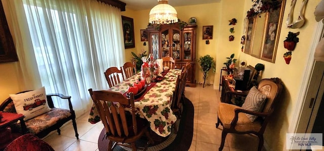 dining area featuring an inviting chandelier and light tile patterned floors