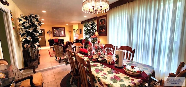 dining room featuring a chandelier, light tile patterned flooring, and recessed lighting