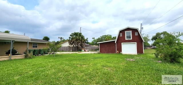 view of yard with an outbuilding, a barn, a garage, and fence