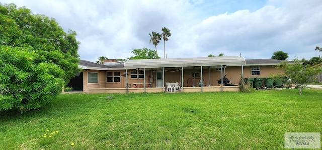 back of house with a lawn