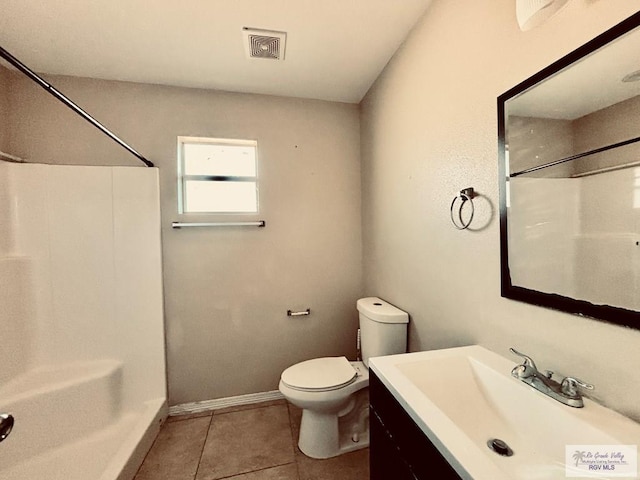 bathroom with a shower, tile patterned flooring, vanity, and toilet