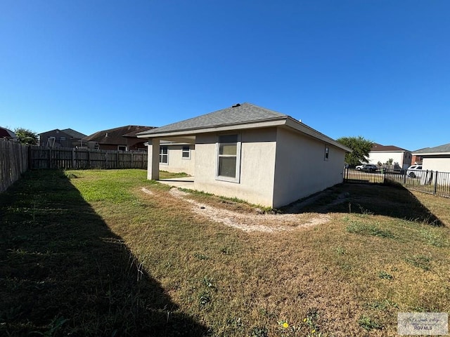 back of property featuring a yard