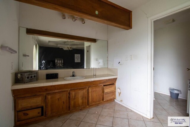 123 Maine St, Santa Rosa, TX 78593 - bathroom with vanity, ceiling fan, decorative backsplash, and tile patterned flooring