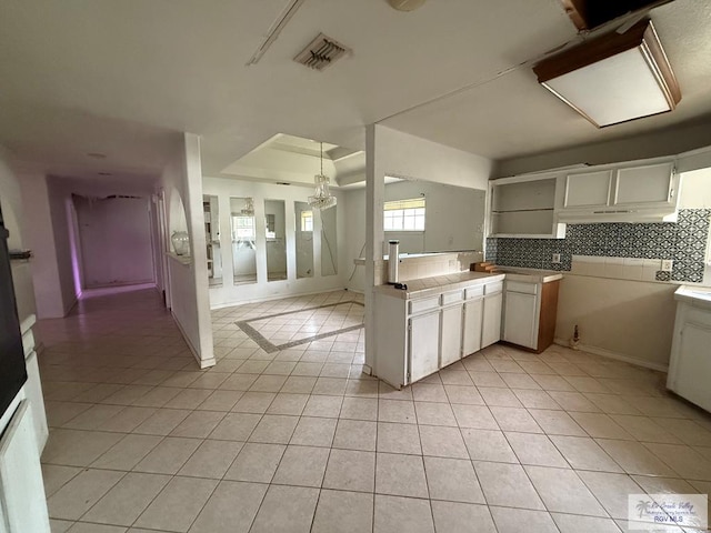123 Maine St, Santa Rosa, TX 78593 - kitchen with visible vents, decorative backsplash, open shelves, light countertops, and light tile patterned floors