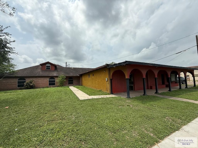 123 Maine St, Santa Rosa, TX 78593 - view of front of home with brick siding and a front yard