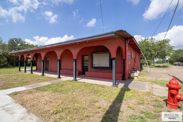 123 Maine St, Santa Rosa, TX 78593 - view of front of house with covered porch, brick siding, and a front yard