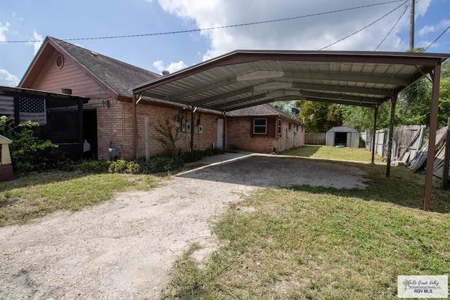 123 Maine St, Santa Rosa, TX 78593 - view of front of property featuring a storage shed, fence, brick siding, an outdoor structure, and dirt driveway