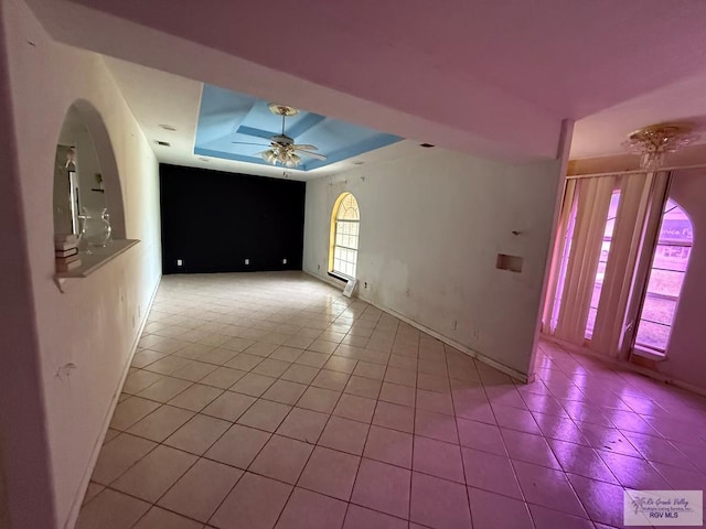 123 Maine St, Santa Rosa, TX 78593 - spare room featuring a raised ceiling, tile patterned floors, baseboards, and ceiling fan