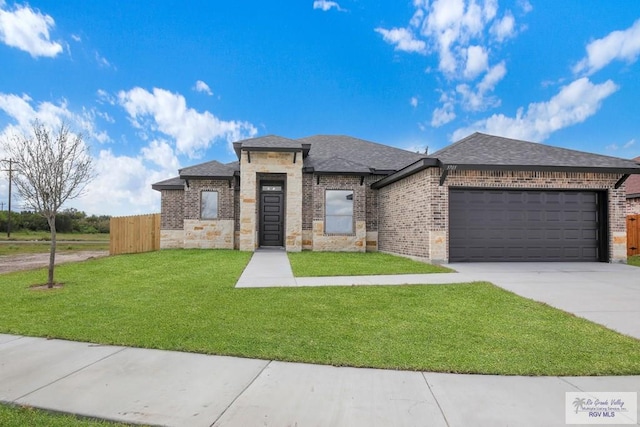 view of front of house with a garage and a front lawn