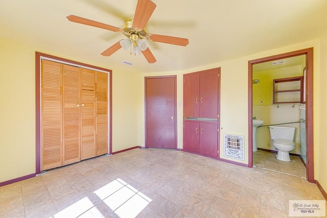 22916 N Oscar St, Harlingen, TX 78552 - unfurnished bedroom featuring heating unit, a ceiling fan, and ensuite bathroom