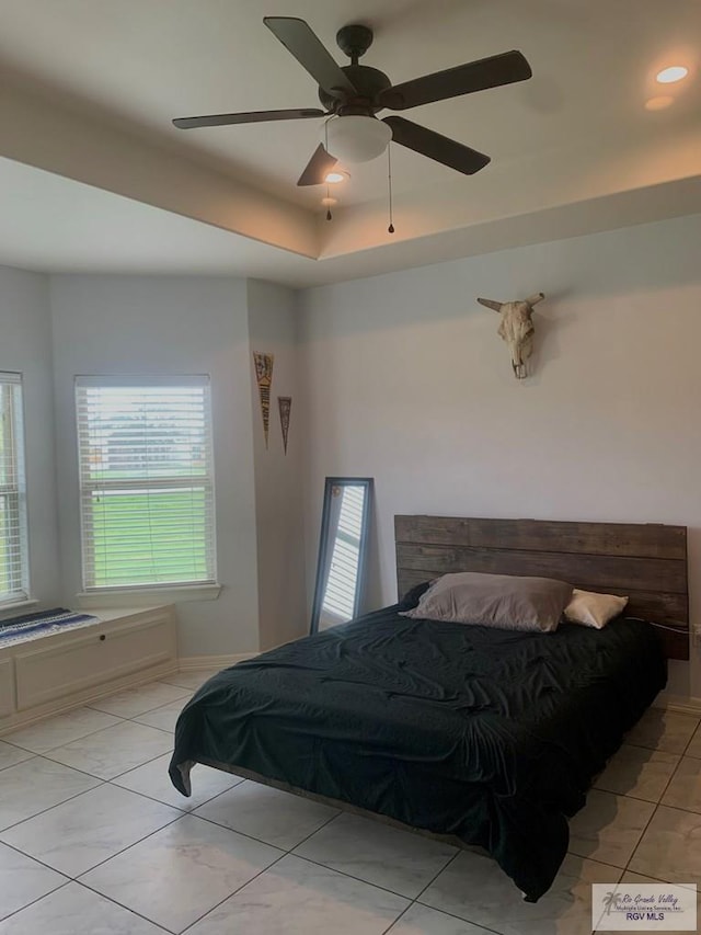 bedroom with ceiling fan and light tile patterned floors