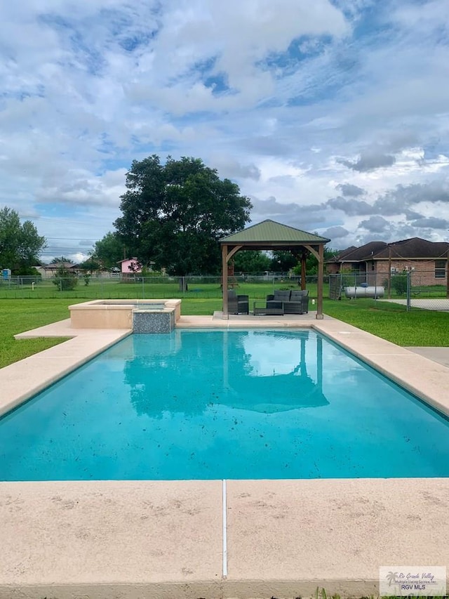 view of swimming pool with a gazebo, an in ground hot tub, and a lawn