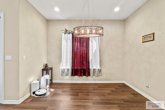 interior space featuring dark hardwood / wood-style floors and an inviting chandelier