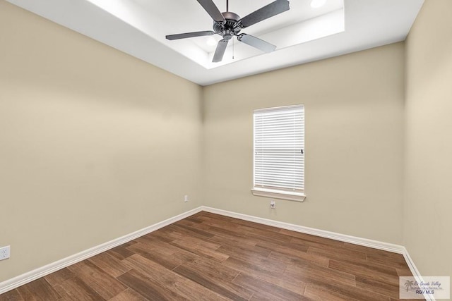 spare room with hardwood / wood-style floors and ceiling fan