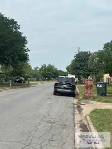 1022 Madison Ave, Harlingen, TX 78550 - view of asphalt road with curbs and street lighting