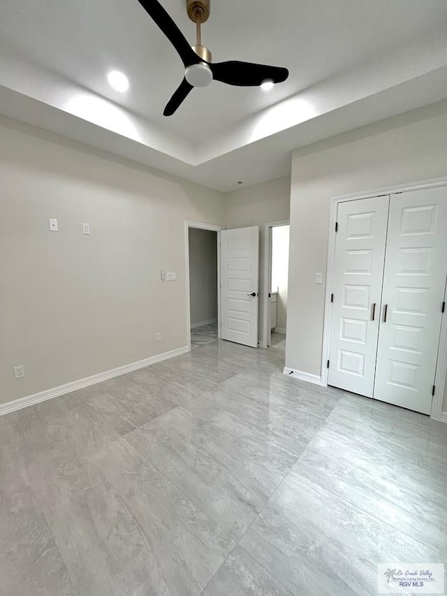 interior space with ceiling fan