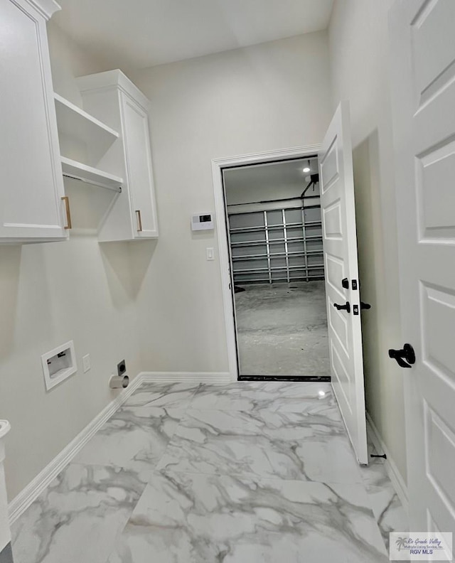 laundry area featuring hookup for a washing machine, cabinets, and hookup for an electric dryer