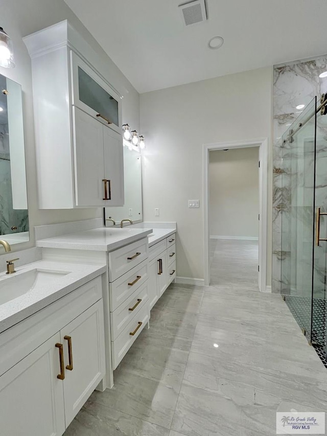 bathroom with vanity and a shower with door