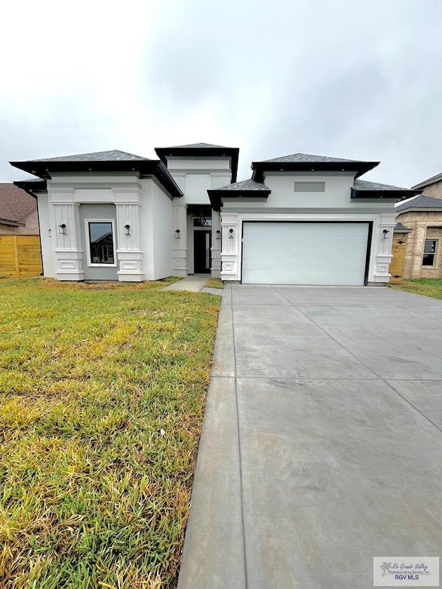 prairie-style house with a front lawn and a garage