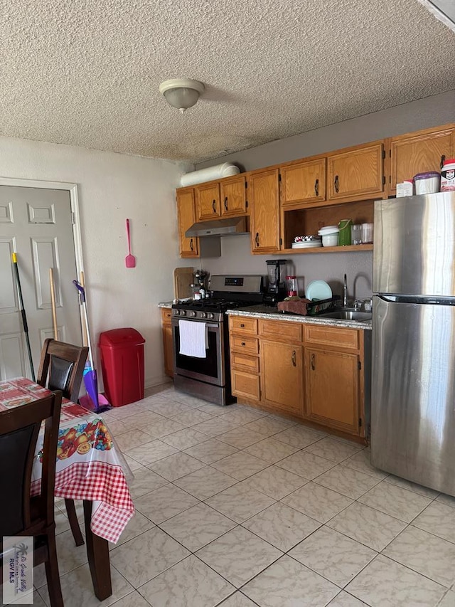 kitchen with open shelves, a sink, brown cabinets, appliances with stainless steel finishes, and under cabinet range hood