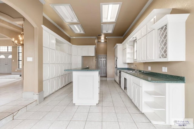 2107 S Victoria Rd, Donna, TX 78537 - kitchen featuring a kitchen island, crown molding, open shelves, and dark countertops