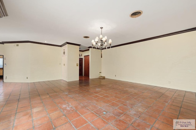 spare room with crown molding and a notable chandelier