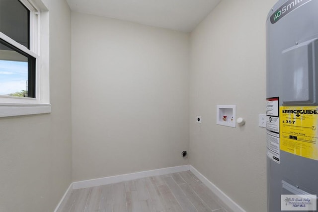 laundry room with hookup for a washing machine, laundry area, water heater, and baseboards