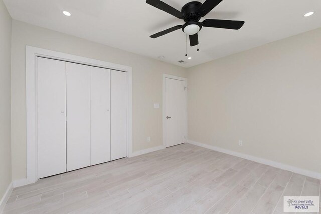 unfurnished bedroom with light wood-style flooring, recessed lighting, a ceiling fan, baseboards, and a closet