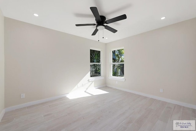 spare room featuring recessed lighting, baseboards, ceiling fan, and light wood finished floors