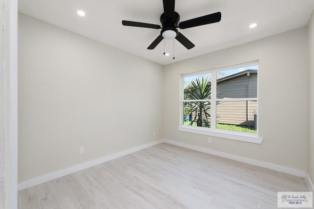 empty room featuring light wood-type flooring, baseboards, and recessed lighting