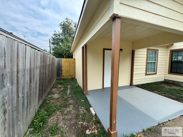 1017 E Austin Ave, Harlingen, TX 78550 - view of side of home with a patio and a fenced backyard