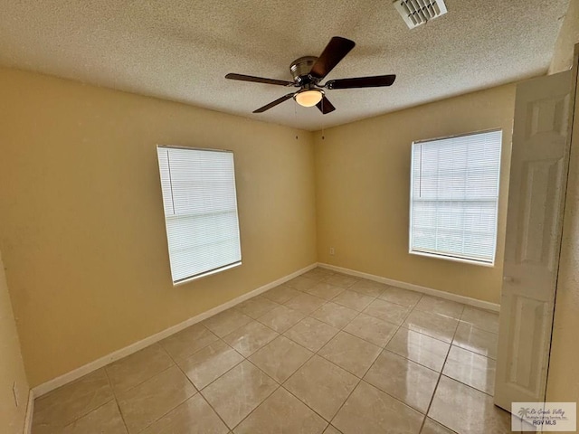 1017 E Austin Ave, Harlingen, TX 78550 - unfurnished room with ceiling fan, light tile patterned floors, a textured ceiling, and baseboards