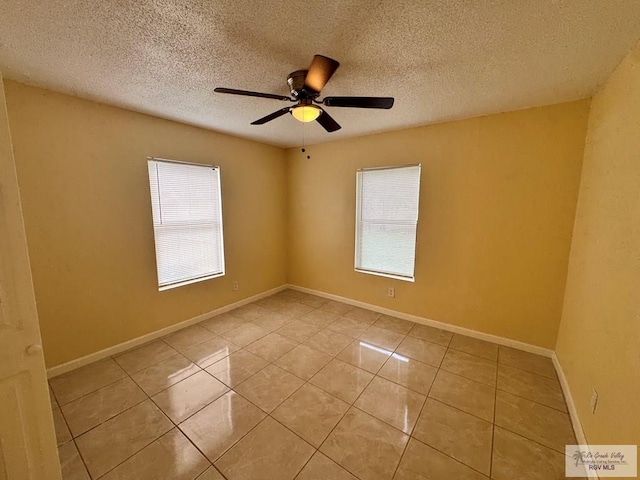 1017 E Austin Ave, Harlingen, TX 78550 - spare room featuring tile patterned floors, a textured ceiling, ceiling fan, and baseboards
