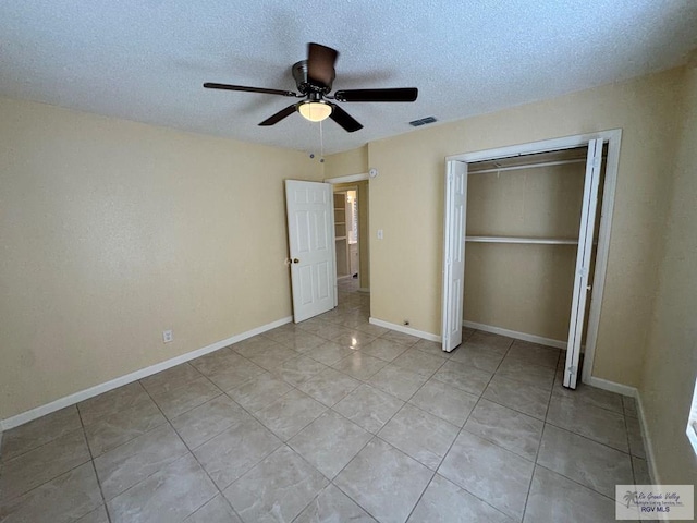 1017 E Austin Ave, Harlingen, TX 78550 - unfurnished bedroom featuring light tile patterned floors, a closet, a textured ceiling, a ceiling fan, and baseboards
