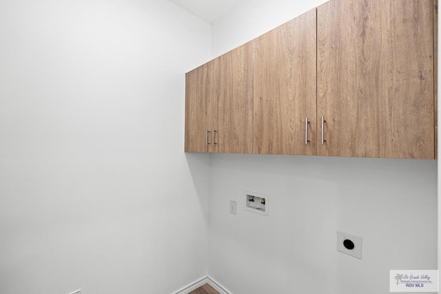 clothes washing area featuring cabinets, washer hookup, and electric dryer hookup