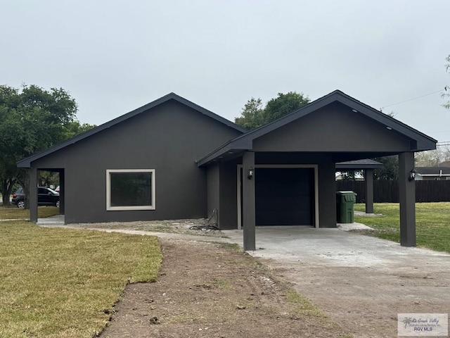 view of front of house with a garage, a carport, and a front yard