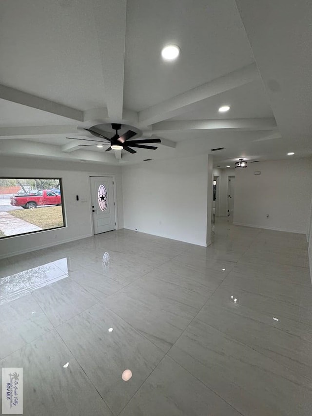 spare room featuring beamed ceiling and ceiling fan