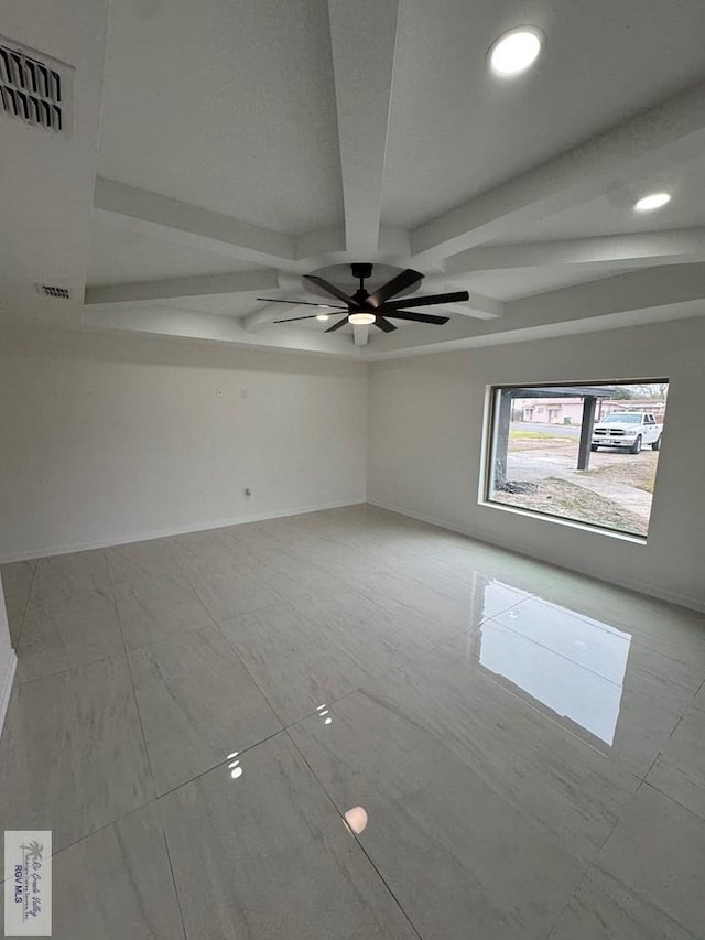 spare room featuring beam ceiling and ceiling fan